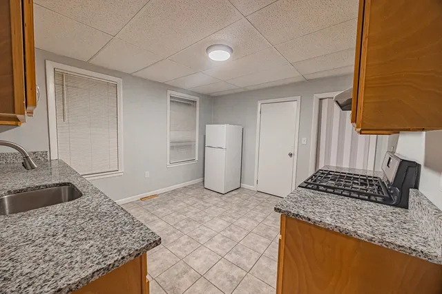 a kitchen with a stove and a refrigerator