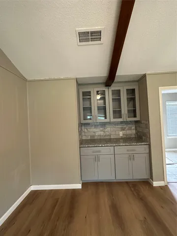 a bathroom with granite countertop a sink and a mirror