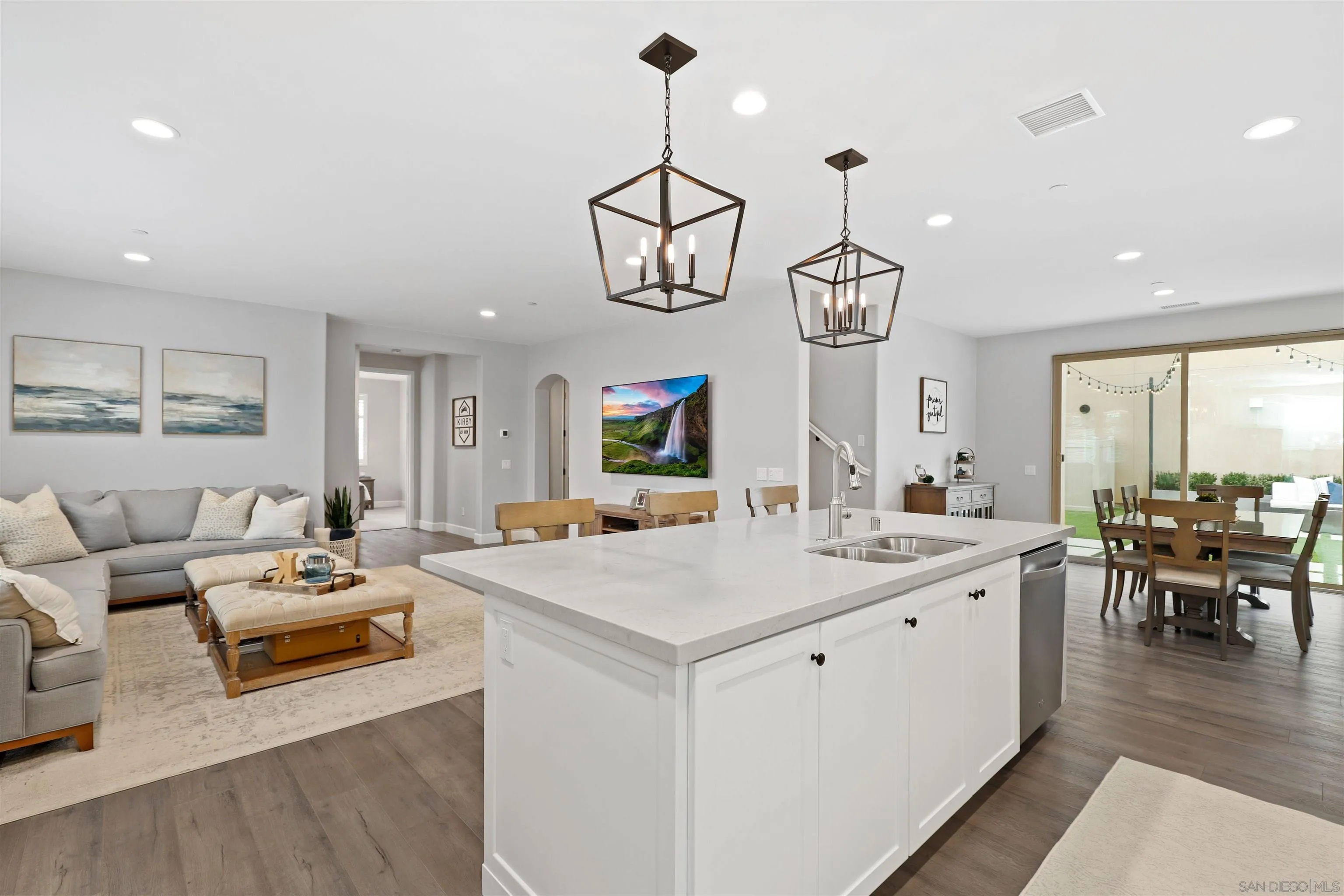 655 Gemstone Drive San Marcos, CA 92078 - Photo 13 of 48 a view of dining room kitchen island stainless steel appliances wooden floor dining table and chairs