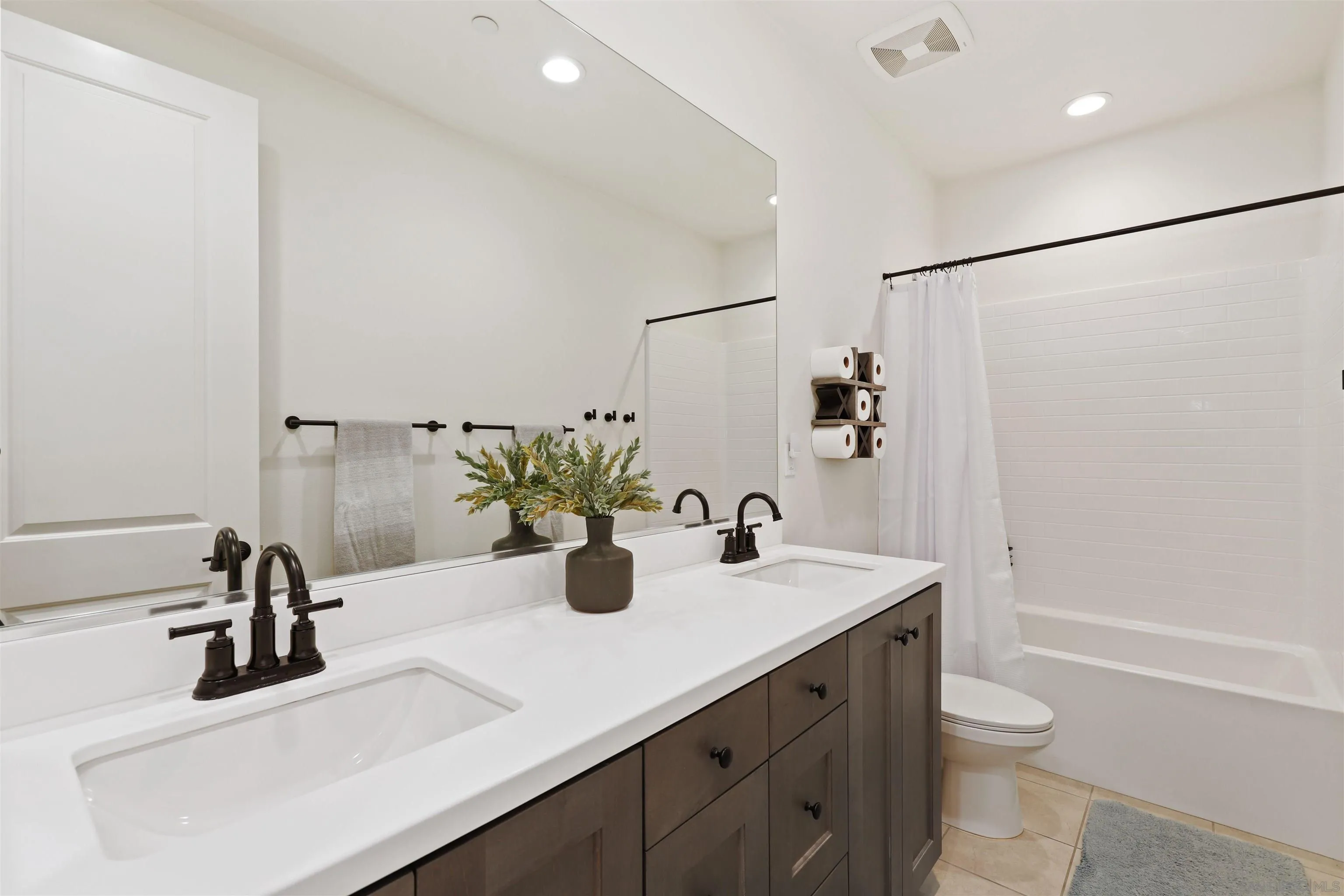 655 Gemstone Drive San Marcos, CA 92078 - Photo 23 of 48 a bathroom with a sink a toilet and shower