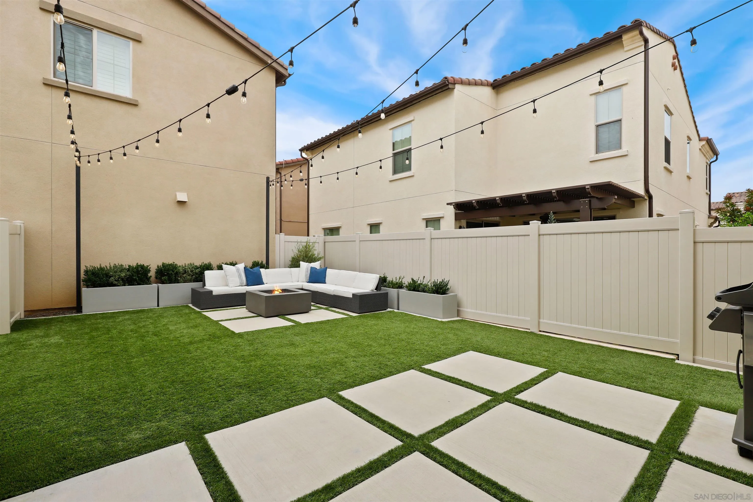 655 Gemstone Drive San Marcos, CA 92078 - Photo 32 of 48 a backyard of a house with table and chairs