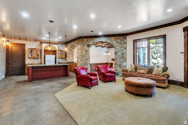 811 South High Ridge Drive Alpine, UT 84004 - Photo 39 of 98 Living room with bar with sink, arched walkways, recessed lighting, and concrete floors