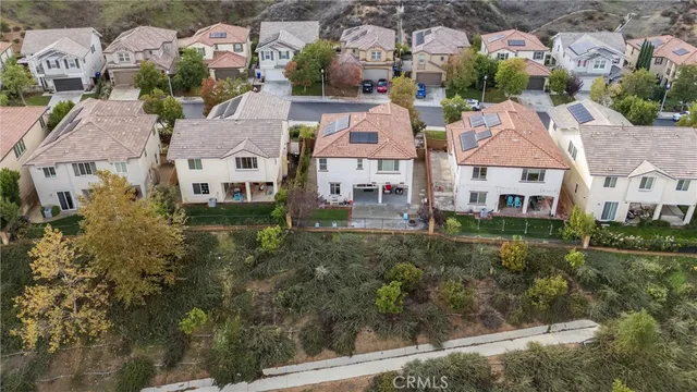 a aerial view of a house with a big yard and large tree
