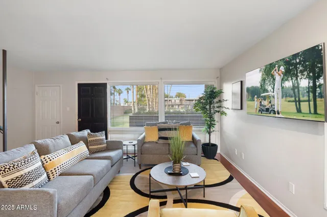 a living room with furniture and a table