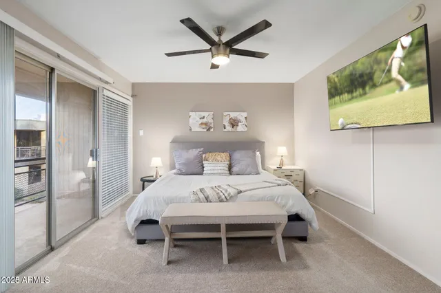 a bedroom with a bed and a painting on the wall