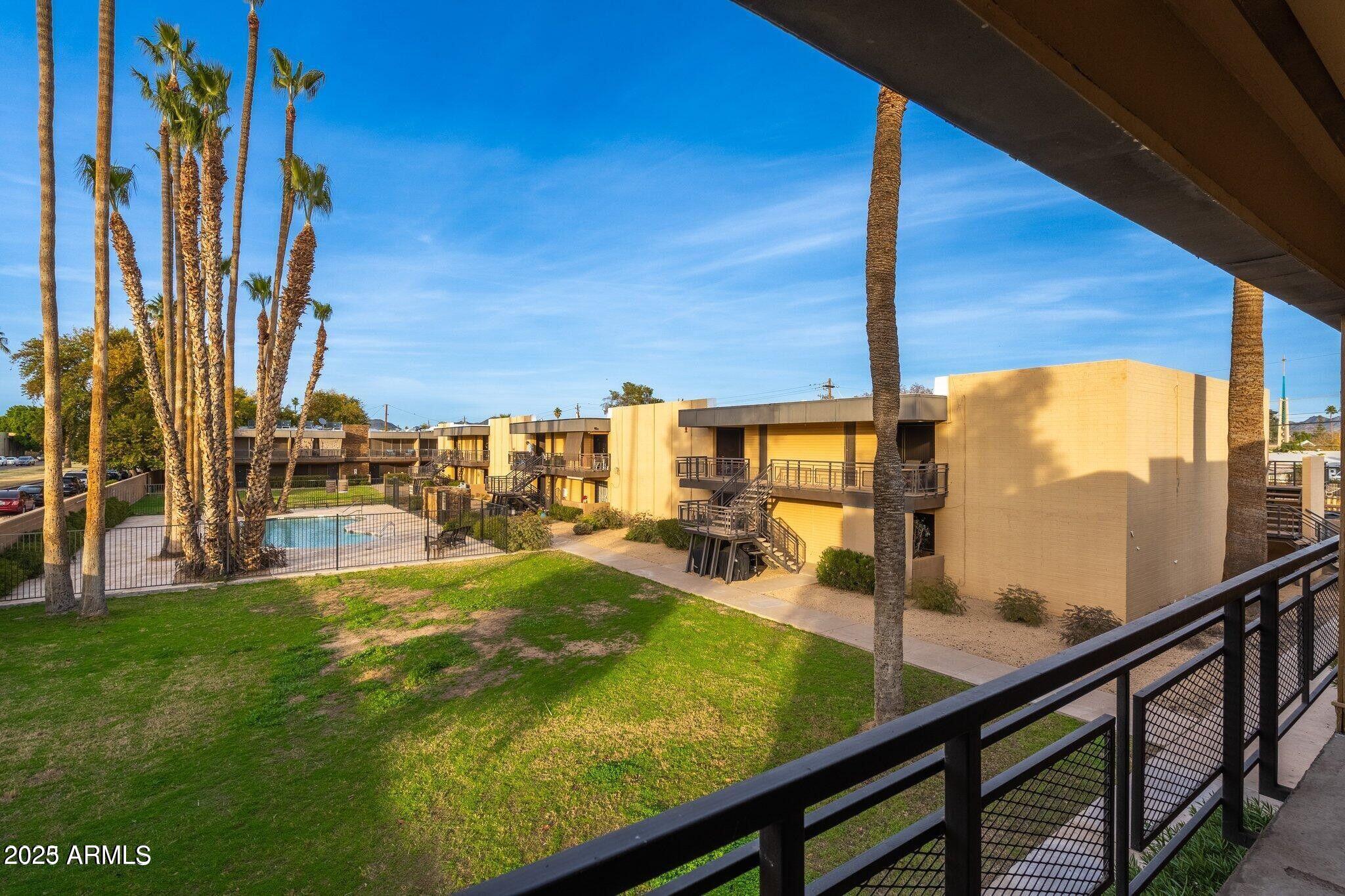 6501 North 17th Avenue, Unit 101 Phoenix, AZ 85015 - Photo 20 of 27 a view of a swimming pool with a chair and tables