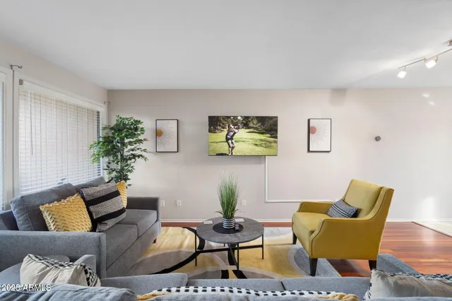 a living room with furniture and wooden floor