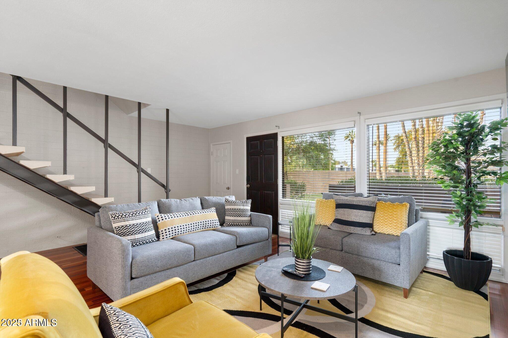 6501 North 17th Avenue, Unit 101 Phoenix, AZ 85015 - Photo 5 of 27 a living room with furniture and floor to ceiling windows