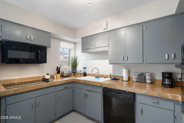 a kitchen with a sink and cabinets