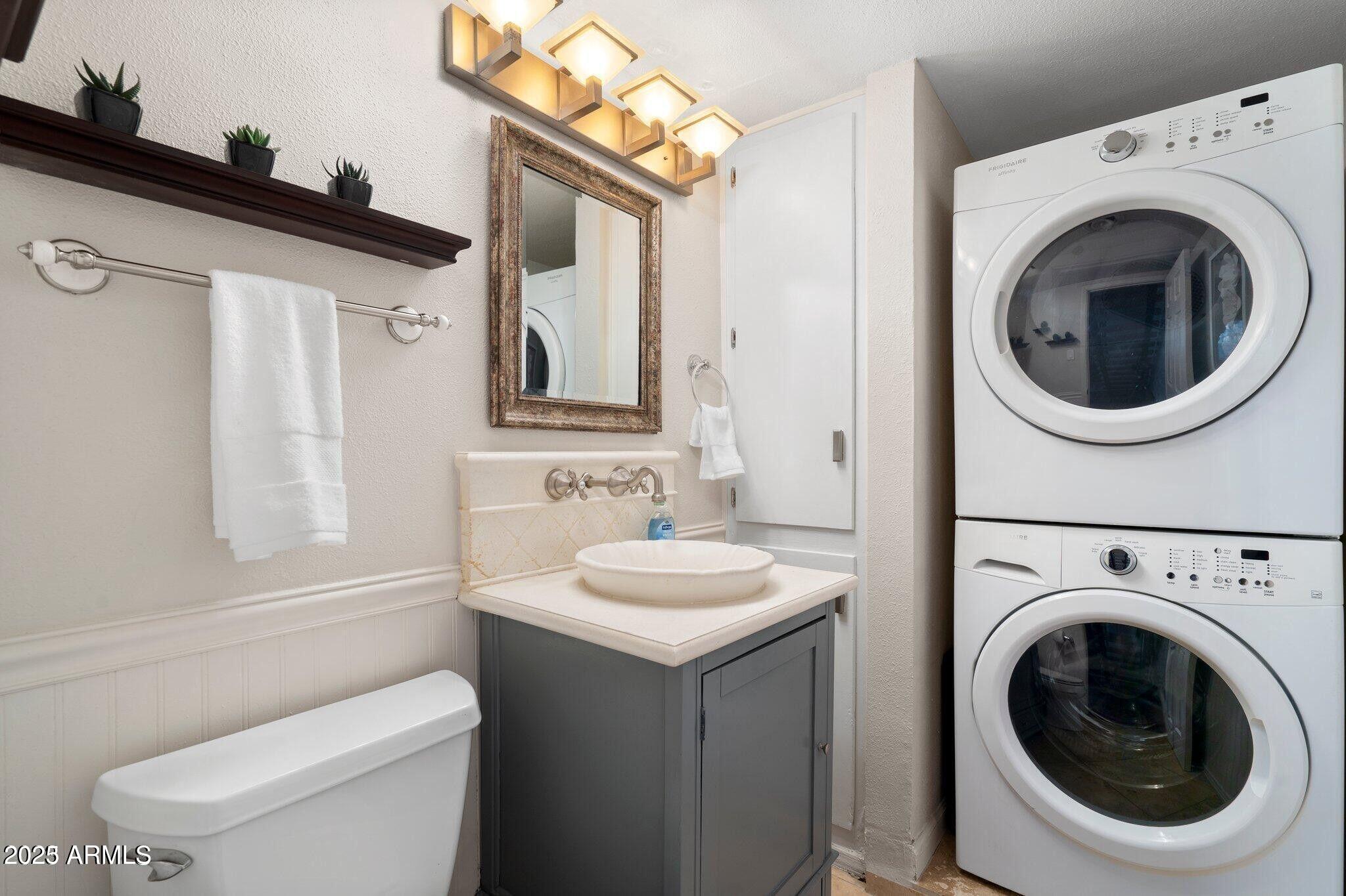 6501 North 17th Avenue, Unit 101 Phoenix, AZ 85015 - Photo 10 of 27 a bathroom with a sink a toilet and a mirror