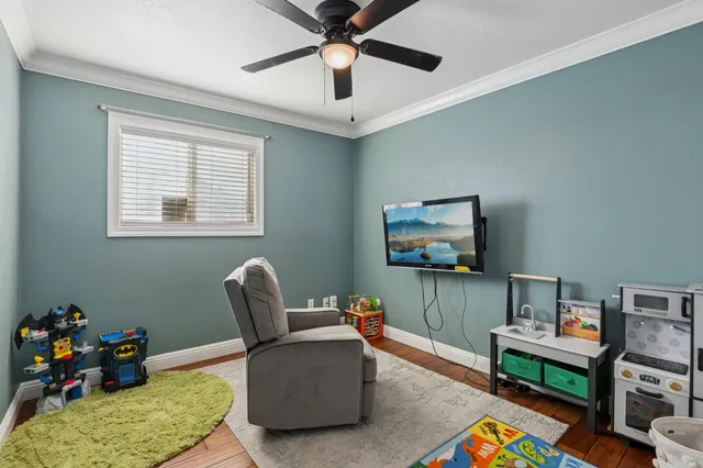 a living room with furniture and a wooden floor