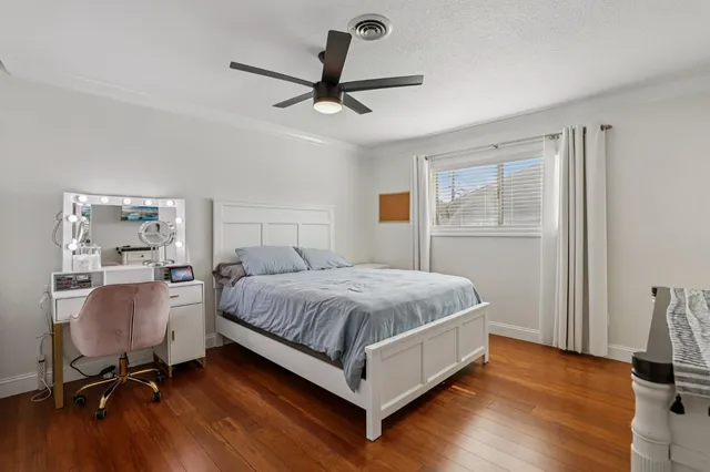 a bedroom with a bed and a desk