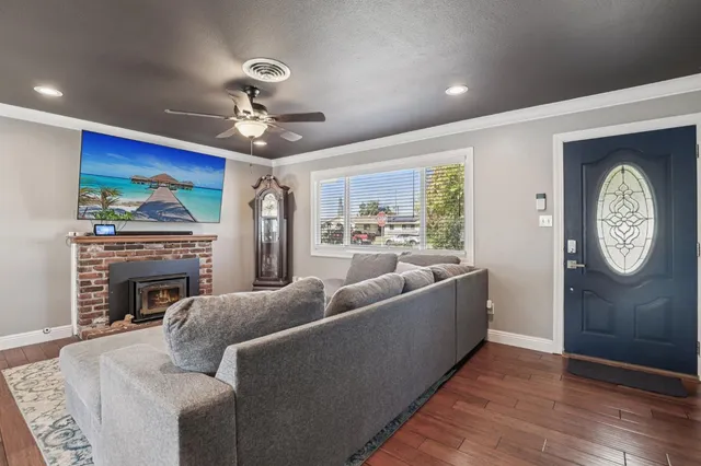 a living room with furniture a chandelier and a fireplace