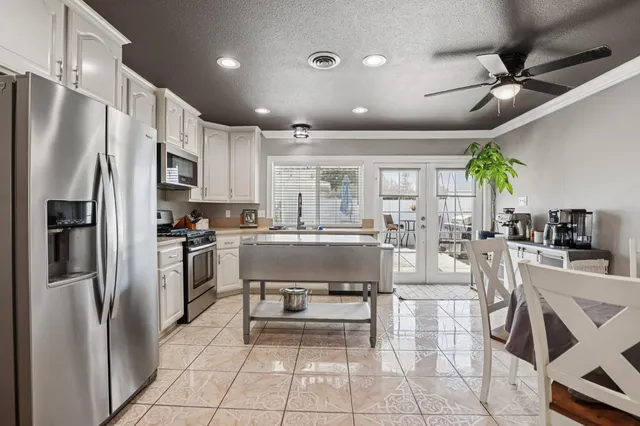 a kitchen with stainless steel appliances a refrigerator sink and cabinets