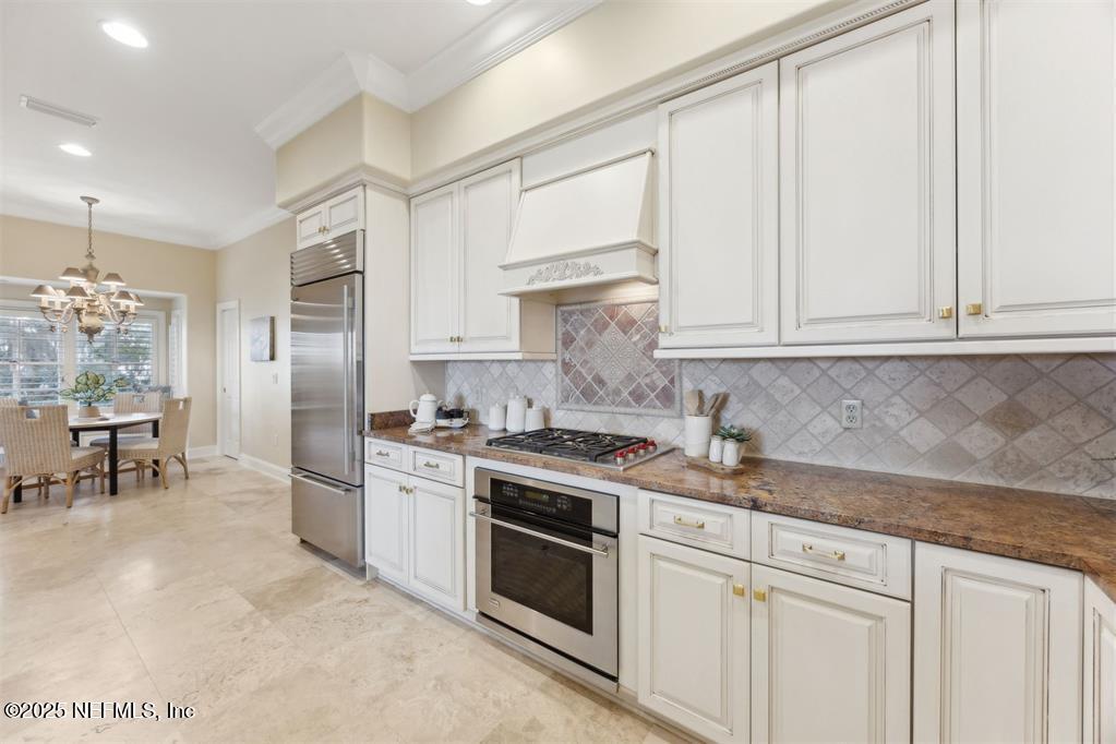 95178 Spring Tide Lane Fernandina Beach, FL 32034 - Photo 14 of 67 a kitchen with stainless steel appliances granite countertop a stove a refrigerator and a white cabinets