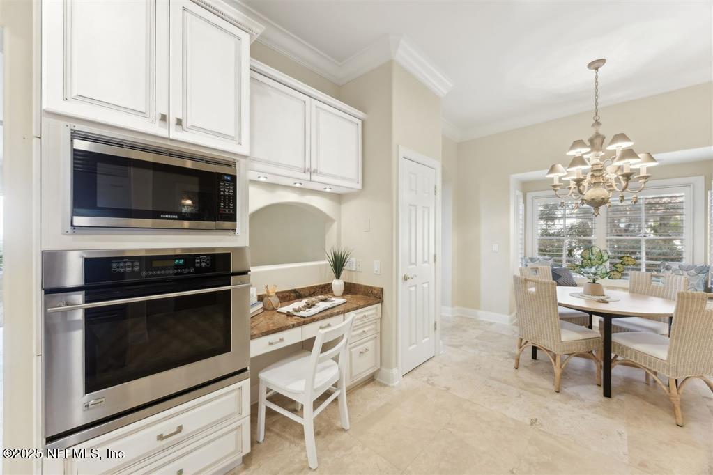95178 Spring Tide Lane Fernandina Beach, FL 32034 - Photo 15 of 67 a kitchen with stainless steel appliances a stove a microwave and cabinets