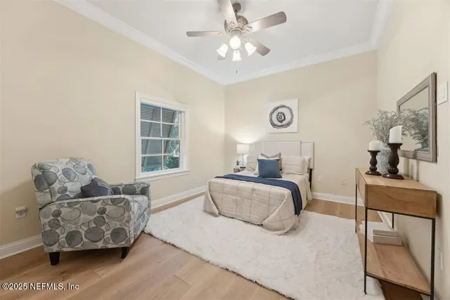 a bedroom with bed and a chandelier