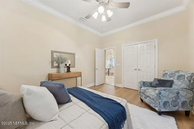 a bedroom with a bed and a chandelier