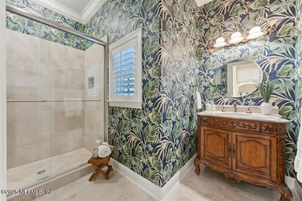 95178 Spring Tide Lane Fernandina Beach, FL 32034 - Photo 27 of 67 a bathroom with a sink a mirror and a shower