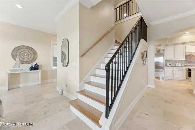 a view of a hallway with wooden floor and a living room