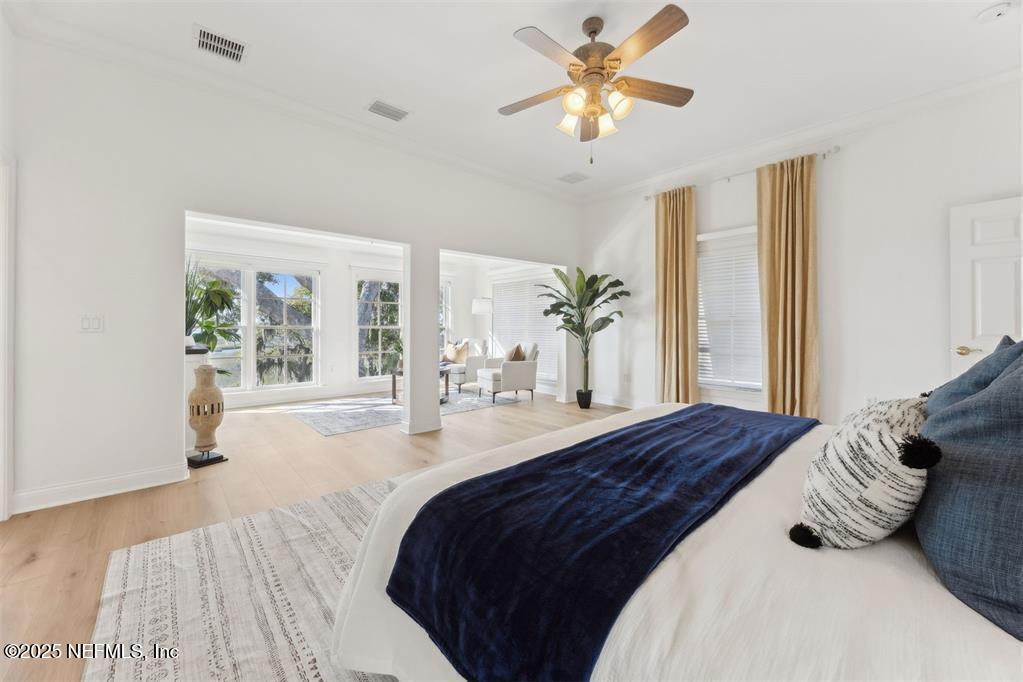 95178 Spring Tide Lane Fernandina Beach, FL 32034 - Photo 29 of 67 a bedroom with a large bed and a chandelier