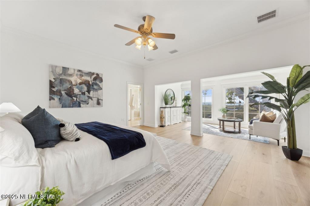 95178 Spring Tide Lane Fernandina Beach, FL 32034 - Photo 3 of 67 a bedroom with a large bed and a chandelier