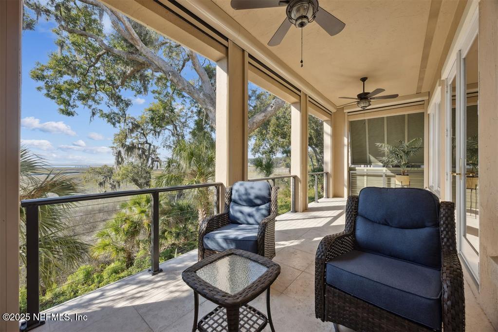 95178 Spring Tide Lane Fernandina Beach, FL 32034 - Photo 41 of 67 a living room with furniture and a floor to ceiling window