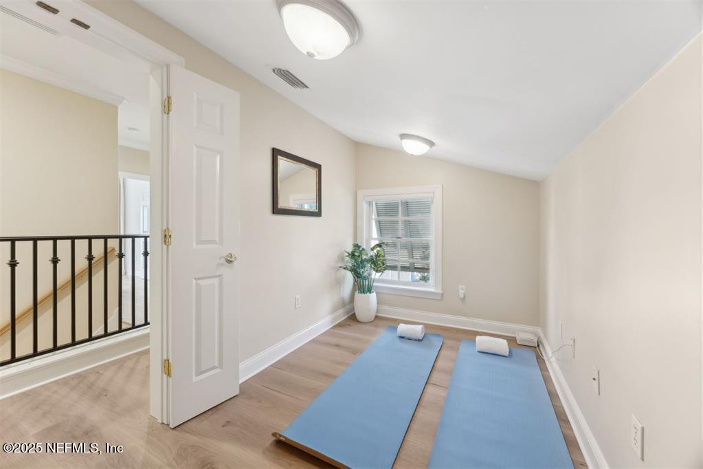 95178 Spring Tide Lane Fernandina Beach, FL 32034 - Photo 49 of 67 a view of a hallway with wooden floor and a living room