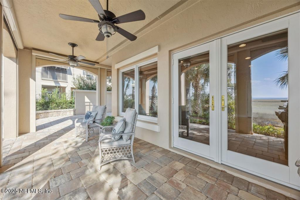 95178 Spring Tide Lane Fernandina Beach, FL 32034 - Photo 56 of 67 a dining room with glass door and glass door