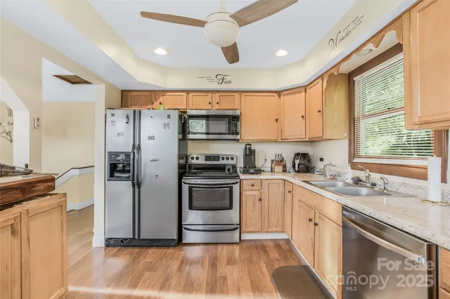 a kitchen with a refrigerator a sink and a stove