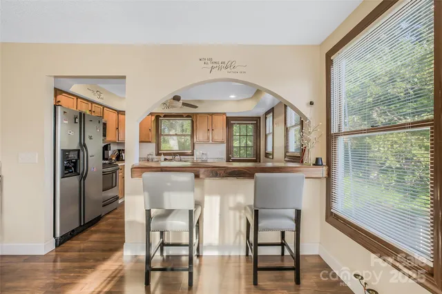 a kitchen with a table chairs refrigerator and cabinets