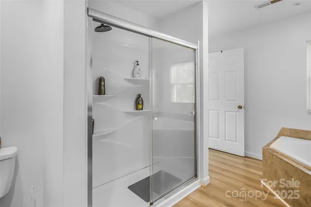 a bathroom with a shower and a glass door
