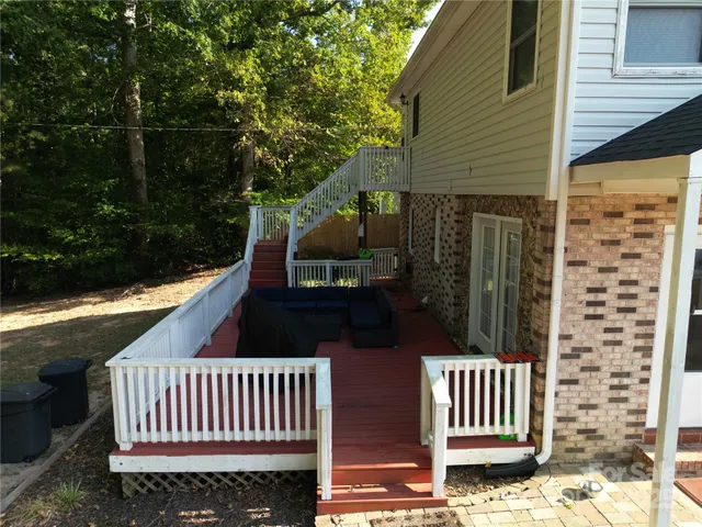 a view of balcony with wooden fence and trees