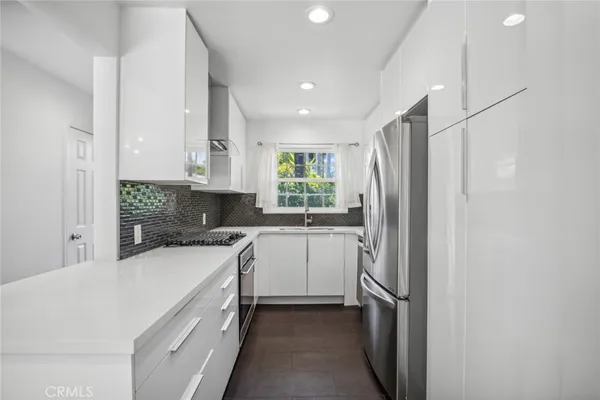 a kitchen with a refrigerator sink and stove