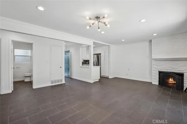 a view of an empty room with a fireplace