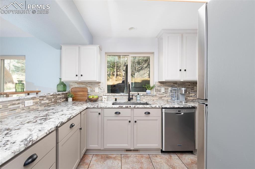 320 Hilton Road Manitou Springs, CO 80829 - Photo 11 of 44 a kitchen with a sink stove and cabinets