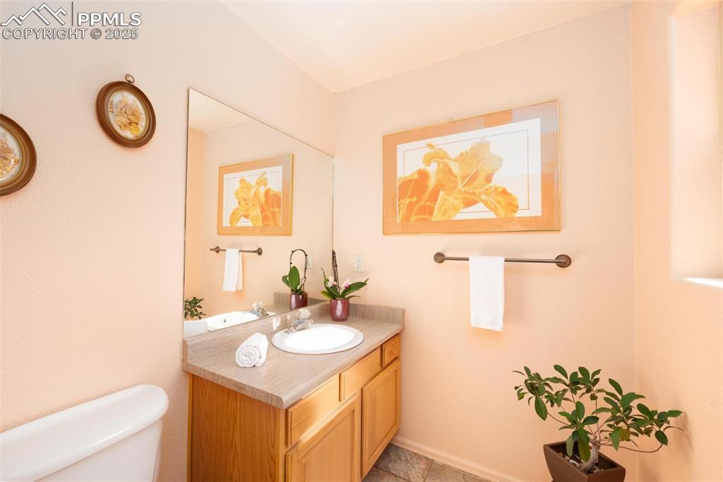 320 Hilton Road Manitou Springs, CO 80829 - Photo 14 of 44 a bathroom with a sink mirror and vanity