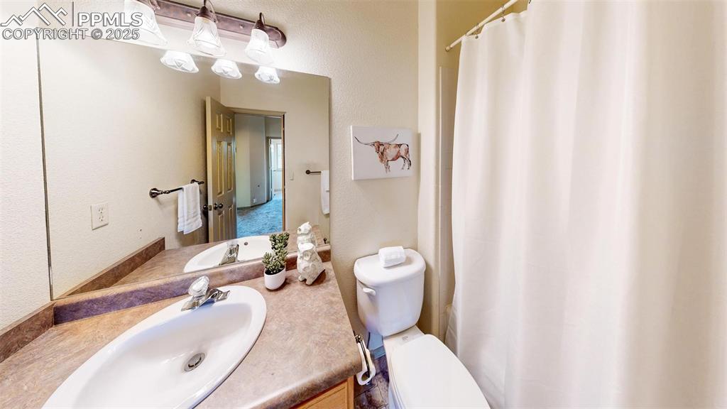 320 Hilton Road Manitou Springs, CO 80829 - Photo 18 of 44 a bathroom with a sink a toilet and shower curtain