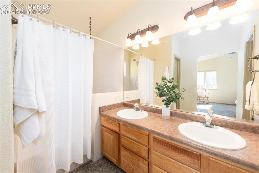 320 Hilton Road Manitou Springs, CO 80829 - Photo 25 of 44 a bathroom with a granite countertop sink and a mirror