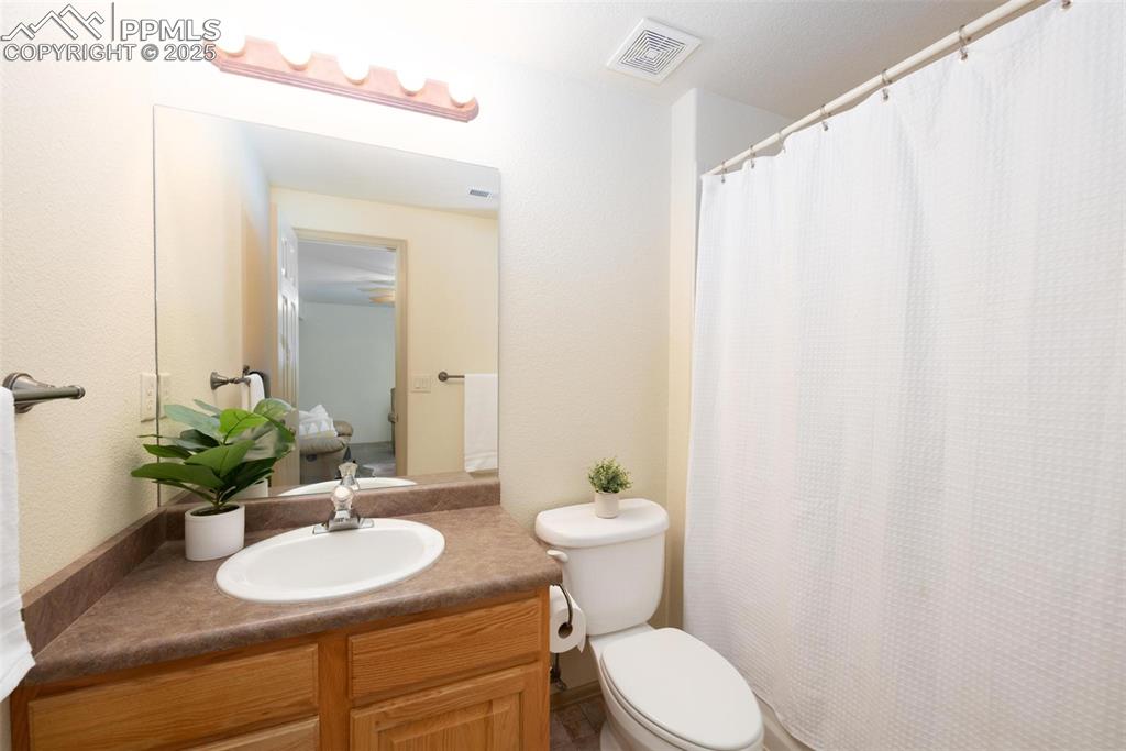 320 Hilton Road Manitou Springs, CO 80829 - Photo 30 of 44 a bathroom with a sink toilet and mirror