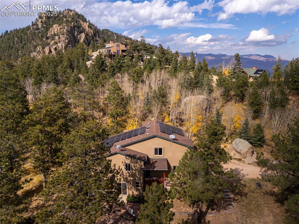 320 Hilton Road Manitou Springs, CO 80829 - Photo 43 of 44 a aerial view of a house with a yard and mountain view in back