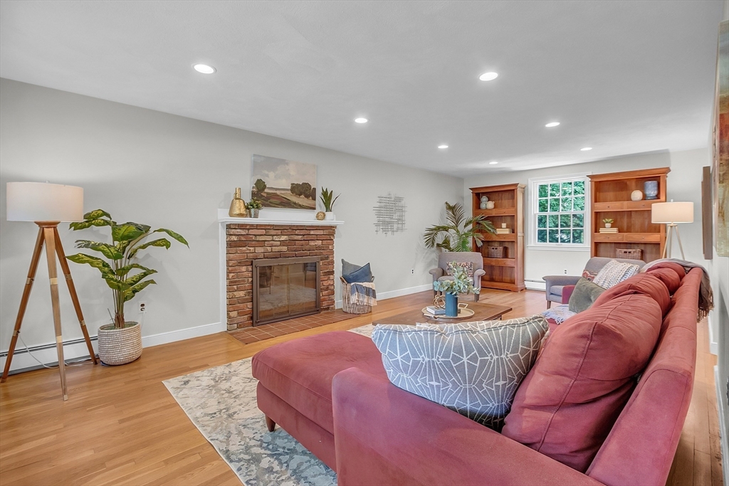 9 Berry Lane Acton, MA 01720 - Photo 14 of 42 a living room with fireplace furniture and a wooden floor