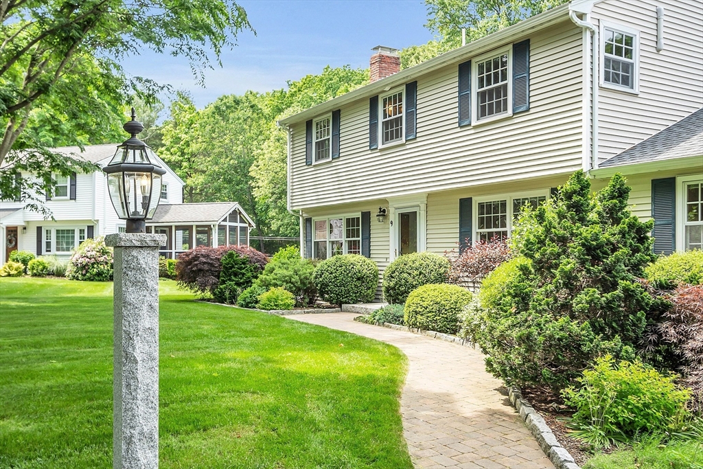 9 Berry Lane Acton, MA 01720 - Photo 2 of 42 a front view of a house with a yard and potted plants