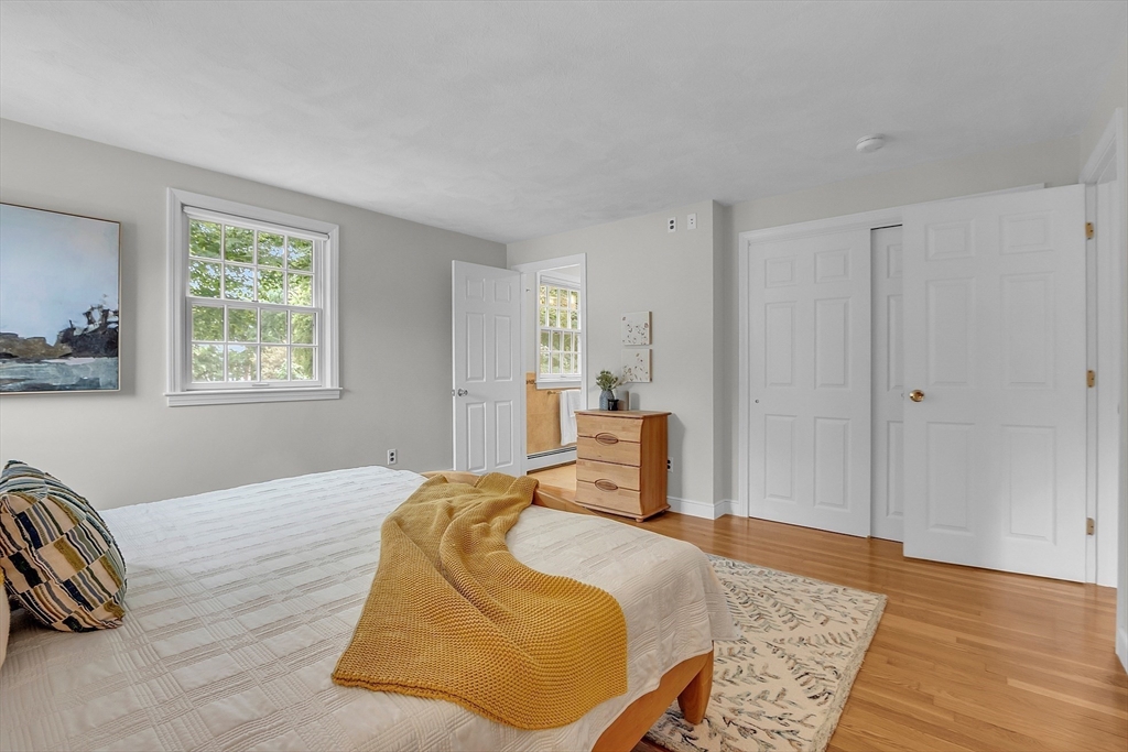 9 Berry Lane Acton, MA 01720 - Photo 23 of 42 a bedroom with a bed and wooden floor