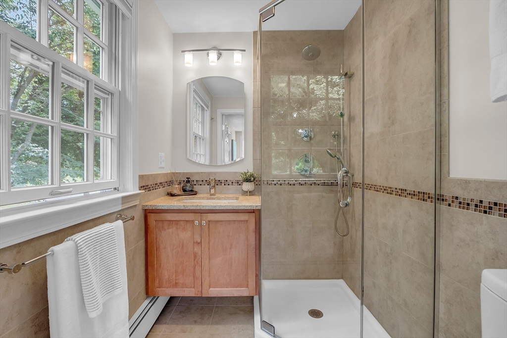 9 Berry Lane Acton, MA 01720 - Photo 24 of 42 a bathroom with a granite countertop sink a mirror and a bathtub