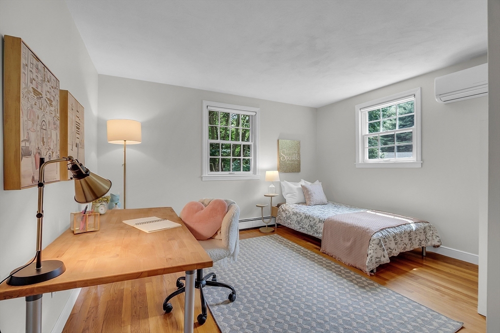 9 Berry Lane Acton, MA 01720 - Photo 25 of 42 a bedroom with a bed and wooden floor