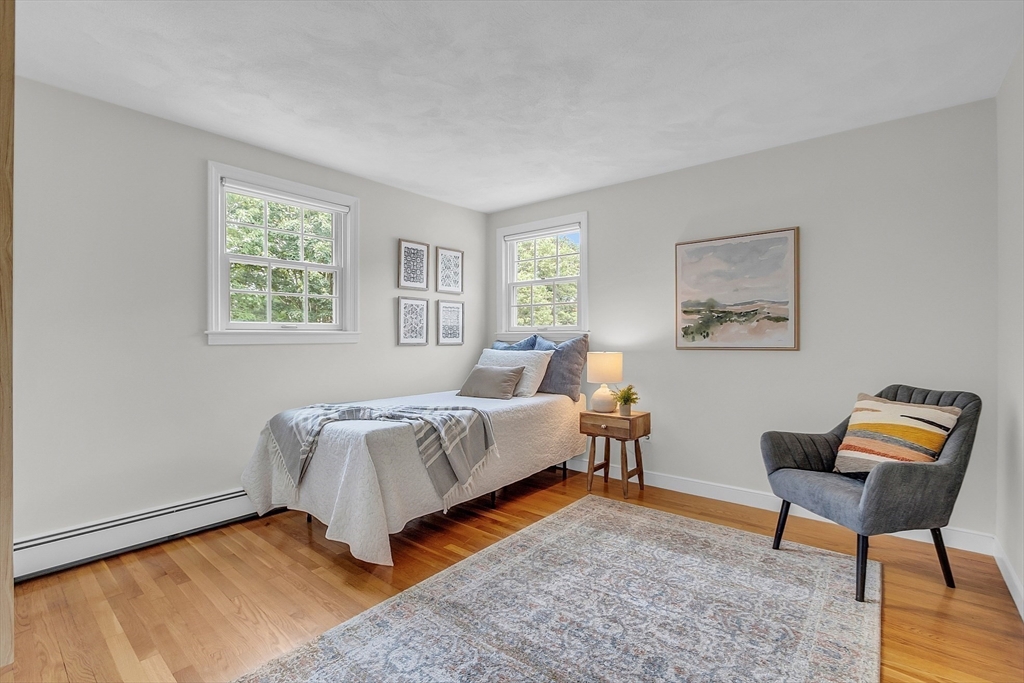 9 Berry Lane Acton, MA 01720 - Photo 29 of 42 a bedroom with a bed and lamp next to a window