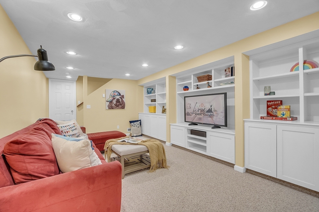 9 Berry Lane Acton, MA 01720 - Photo 32 of 42 a living room with furniture and a flat screen tv