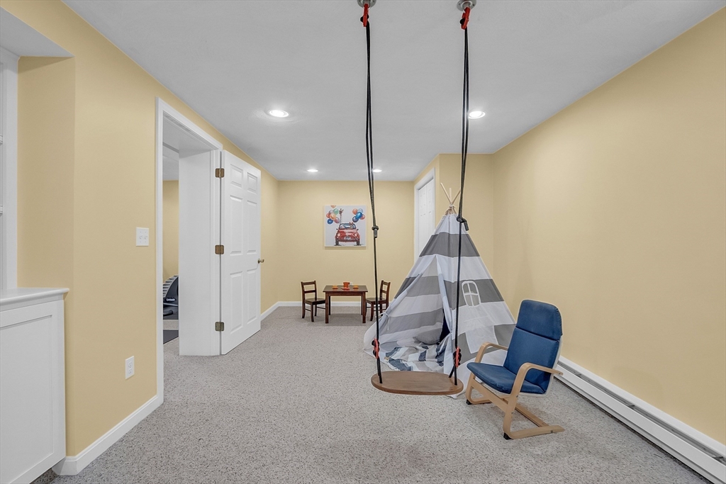 9 Berry Lane Acton, MA 01720 - Photo 33 of 42 a living room with furniture and a chandelier
