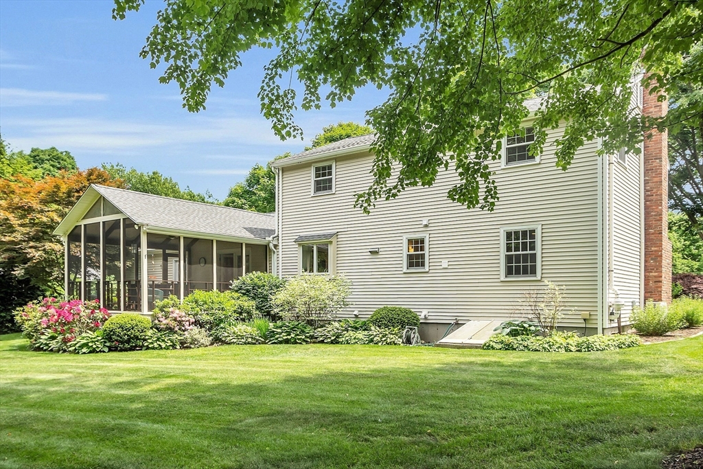9 Berry Lane Acton, MA 01720 - Photo 36 of 42 a front view of a house with a garden